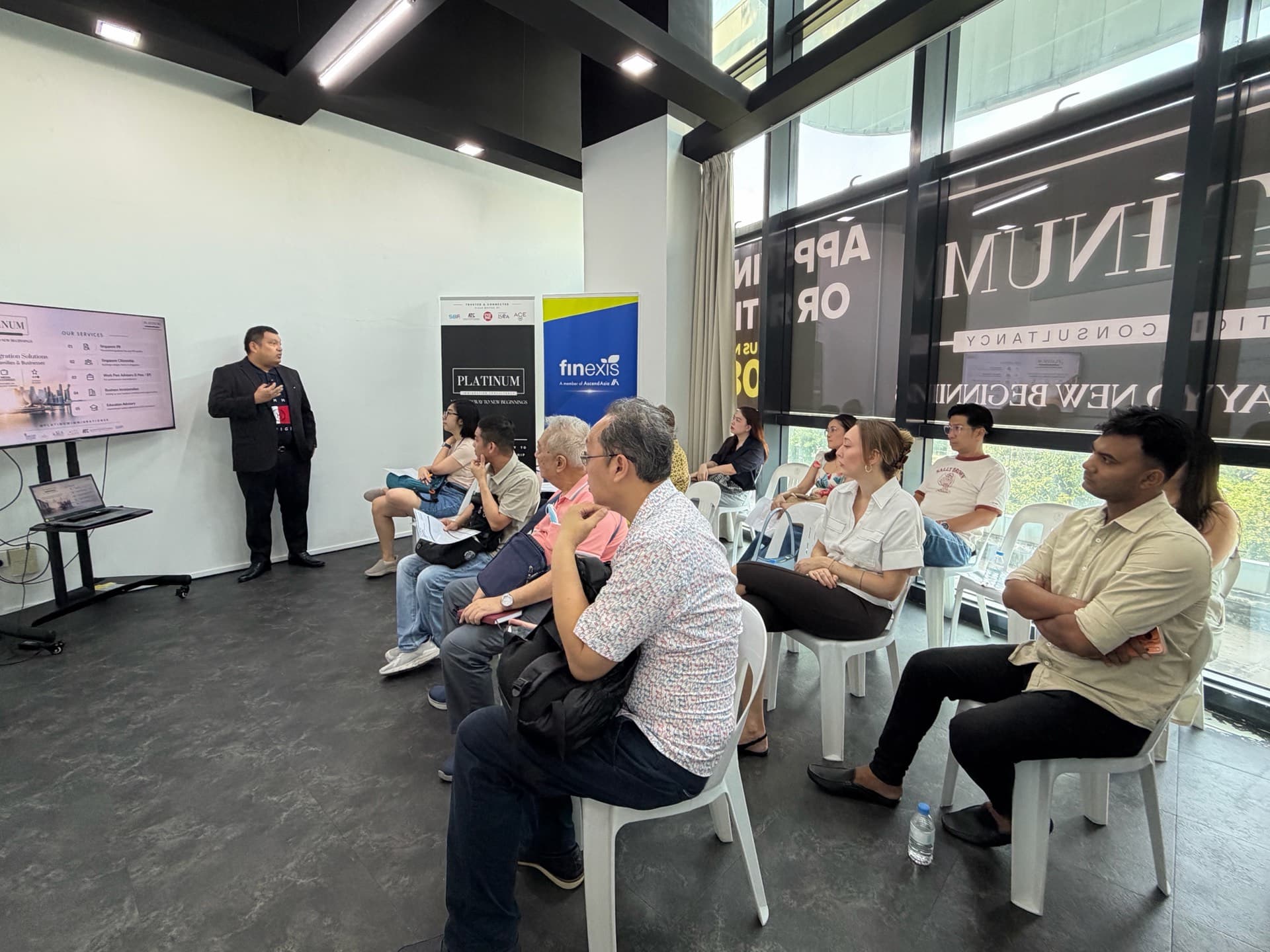 People listening to a talk on Singapore PR and citizenship pathways