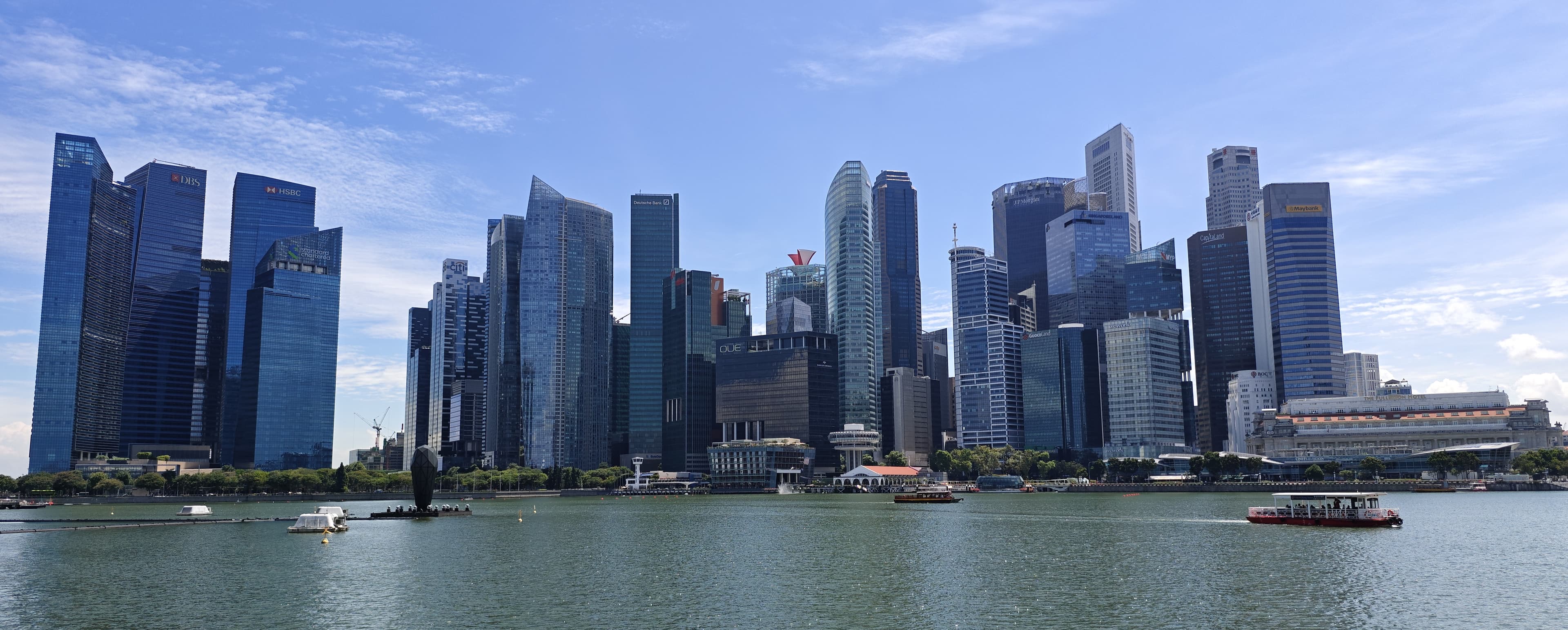 Skyscrapers of Singapore's Central Business District under a daytime sky, the office area where many jobs are based.