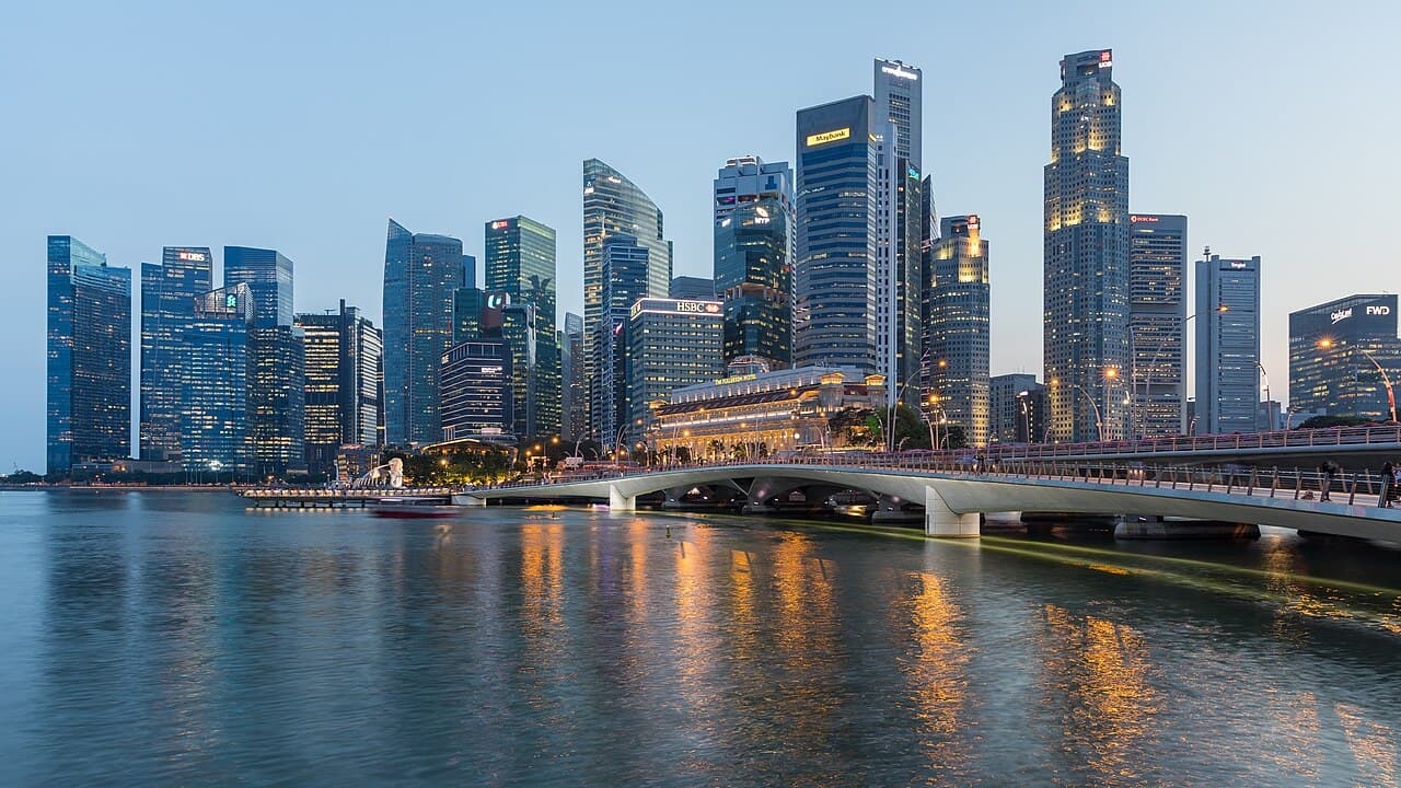 Singapore's Central Business District skyline at dusk, seen across Marina Bay from the Esplanade.